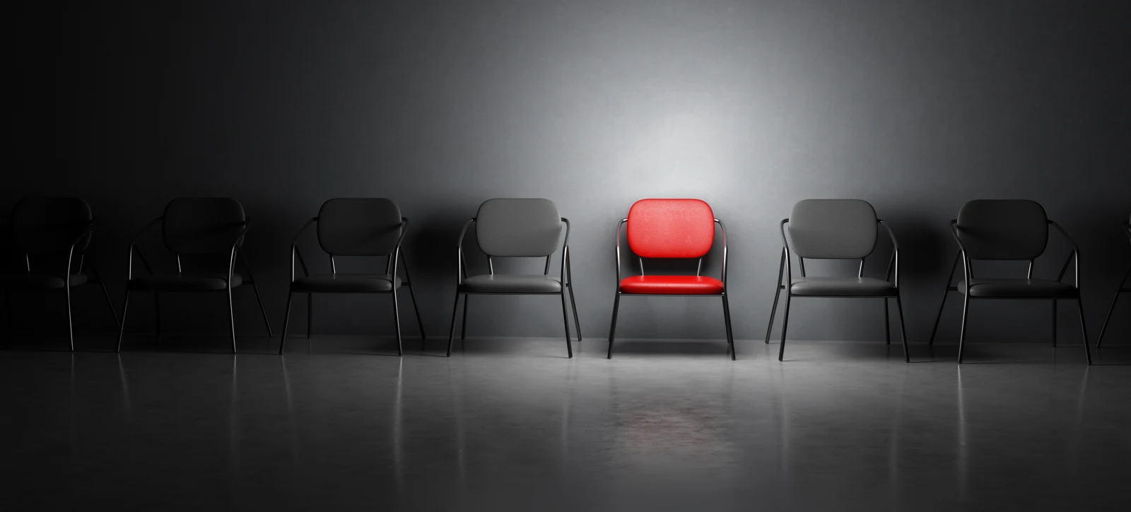 A distinctive red chair among grey chairs